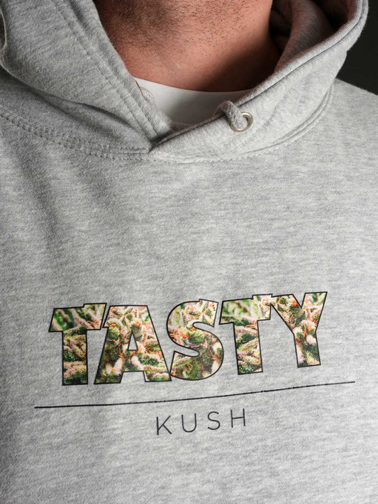 Der TASTY Kush Hoodie Grey zeigt auf der Vorderseite den markanten TASTY Kush Schriftzug – perfekt für OG Kush Fans